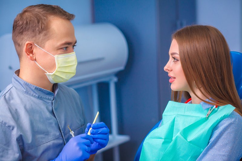 female patient listening to dentist
