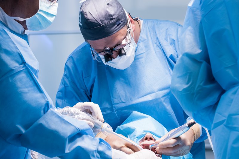 dentists performing dental implant surgery